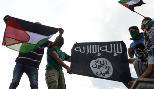 Kashmiri demonstrators hold up Palestinian flags and a flag of the Islamic State of Iraq and the Levant (ISIL) during a demonstration against Israeli military operations in Gaza, in downtown Srinagar on July 18, 2014. The death toll in Gaza hit 265 as Israel pressed a ground offensive on the 11th day of an assault aimed at stamping out rocket fire, medics said. AFP PHOTO/Tauseef MUSTAFA        (Photo credit should read TAUSEEF MUSTAFA/AFP/Getty Images)